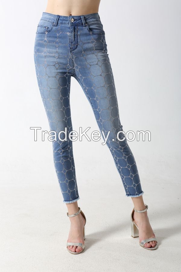 Woman's slim denim jeans with front full rhinestone