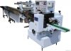 Flow wrapping machine