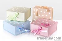 Colorful polka dot paper gift box with ribbon