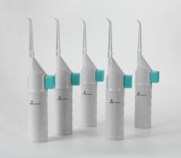 Handheld manual oral irrigator with no cord or battery needed